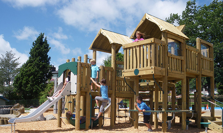 kids play on BigToys treehouse structure on the playground